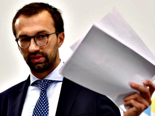 Ukrainian member of parliament Serhiy Leshchenko holds pages showing allegedly signings of