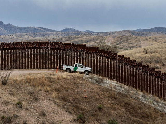 TOPSHOT - A Border Patrol officer sits inside his car as he guards the US/Mexico border fence, in Nogales, Arizona, on February 9, 2019. (Photo by Ariana Drehsler / AFP) (Photo credit should read ARIANA DREHSLER/AFP/Getty Images)