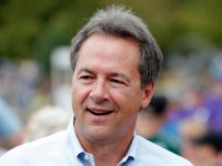Montana Gov. Steve Bullock walks down the main concourse during a visit to the Iowa State Fair, Thursday, Aug. 16, 2018, in Des Moines, Iowa. (AP Photo/Charlie Neibergall)