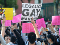 Peo-same sex marriage demonstrators display the sign outside the Parliament in Taipei on November 30, 2013. Opponents and supporters of same-sex marriages took to the streets in Taiwan amid an ongoing debate in parliament over a controversial bill to legalise such unions. AFP PHOTO / Sam Yeh (Photo credit should …