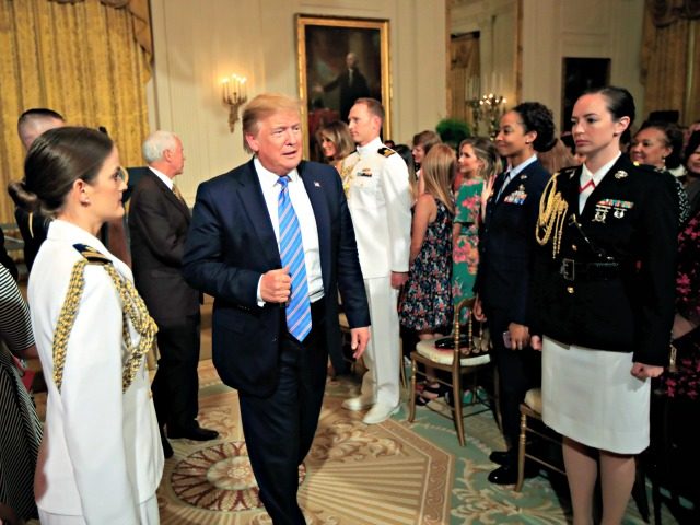 President Donald Trump leaves the East Room during a celebration of military mothers with