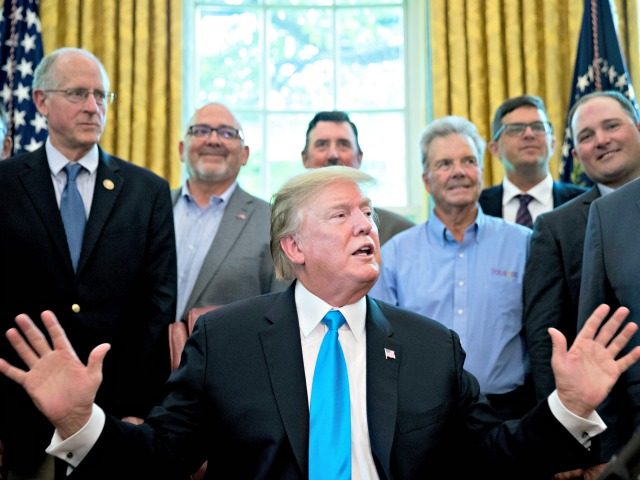 President Donald Trump, accompanied by Rep. Mike Conaway, R-Texas, left, Agriculture Secretary Sonny Perdue, right, and farmers and ranchers, speaks in the Oval Office of the White House, Thursday, May 23, 2019, in Washington. (AP Photo/Andrew Harnik)