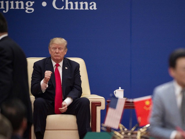 US President Donald Trump (L) gestures during a business leaders event with China's President Xi Jinping inside the Great Hall of the People in Beijing on November 9, 2017. Donald Trump urged Chinese leader Xi Jinping to work "hard" and act fast to help resolve the North Korean nuclear crisis, …
