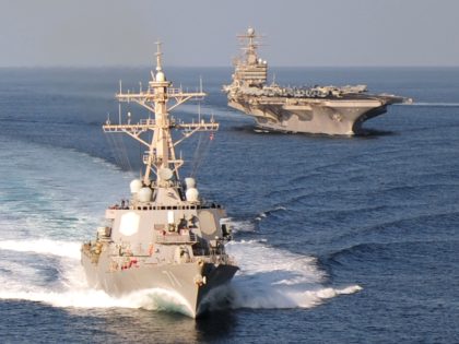 GULF OF OMAN - NOVEMBER 23, 2010: In this handout provided by the U.S. Navy, the guided-missile destroyer USS Ross and the aircraft carrier USS Abraham Lincoln cruise in formation November 23, 2010 in the Gulf of Oman. Ross was one of two destroyers that, according to published reports, fired …
