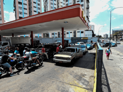 People queue at a gas station in Caracas, on March 10, 2019, during a massive power outage