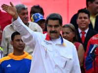 Venezuela's President Nicolas Maduro waves during a rally in front of Miraflores Presidential Palace in Caracas on May 20, 2019. - Embattled Venezuelan President Nicolas Maduro rallied hundreds of his supporters in Caracas on Monday to mark the anniversary of his controversial re-election in May 2018 polls widely denounced as …