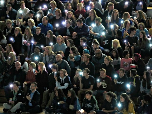 Attendees illuminate their mobile telephones during a community vigil to honor the victims and survivors of yesterday's fatal shooting at the STEM School Highlands Ranch, late Wednesday, May 8, 2019, in Highlands Ranch, Colo. (AP Photo/David Zalubowski)