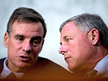 Senate Intelligence Chairman Richard Burr, R-N.C., right, speaks with Committee Vice Chairman Mark Warner, D-Va., left, during a Senate Intelligence Committee hearing on 'Policy Response to Russian Interference in the 2016 U.S. Elections' on Capitol Hill, Wednesday, June 20, 2018, in Washington. (AP Photo/Andrew Harnik)