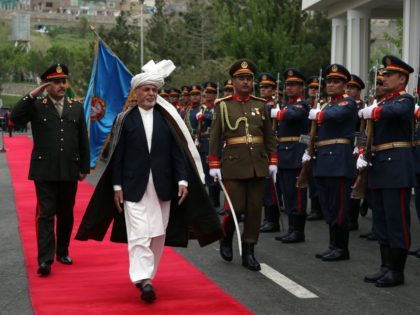 Afghan President Ashraf Ghani (C), inspects a guard of honor during the first day of the Loya Jirga, or the consultative council in Kabul, on April 29, 2019. - Thousands of politicians and officials from across Afghanistan gathered amid tight security in Kabul on April 29 to discuss the war …