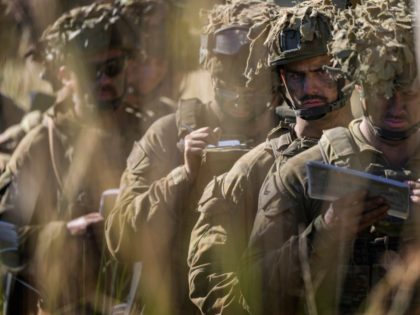 Australian Army soldiers take notes as they are given a safety brief prior to a live fire event at Shoalwater Bay during Exercise Diamond Strike 2018.
