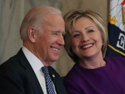 Former US Secretary of State, Hillary Clinton shares a laugh with US Vice President Joseph Biden, during a portrait unveiling ceremony for outgoing Senate Minority Leader Harry Reid (D-NV), on Capitol Hill December 8, 2016 in Washington, DC. (Photo by Mark Wilson/Getty Images)