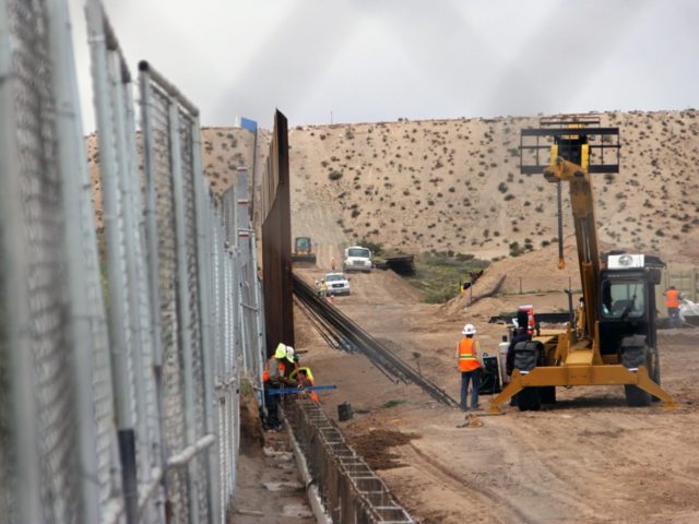 US workers replace fencing with a higher new metal wall along the border between Ciudad Juarez and Sunland Park, New Mexico, in Juarez, Chihuahua state, Mexico on September 12, 2016. / AFP / HERIKA MARTINEZ (Photo credit should read HERIKA MARTINEZ/AFP/Getty Images)