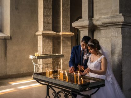 Groom Davit Simonyan, 24, and bride Shogher Hovsepyan, 25, light candles in prayer after their wedding at Ghazanchetsots church on April 18, 2015 in Shushi, Nagorno-Karabakh. Since signing a ceasefire in a war with Azerbaijan in 1994, Nagorno-Karabakh, officially part of Azerbaijan, has functioned as a self-declared independent republic and …