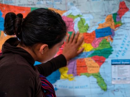 A Guatemalan woman touches a map of the United States at the Casa del Refugiado, or The Ho