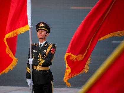 A Chinese honour guard holds a flag ahead of a welcome ceremony for Niger President Mahamadou Issoufou (not pictured) at the Great Hall of the People in Beijing on May 28, 2019. (Photo by NICOLAS ASFOURI / AFP) (Photo credit should read NICOLAS ASFOURI/AFP/Getty Images)