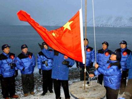 Members of the Chinese Yilite-Mulin Arctic Pole Expedition raise the Chinese national flag in Longyearbyen on Svalbard, Norway, to set the site of a Chinese research station on Wednesday, Oct. 31, 2001. (AP Photo/Xinhua/Yuan Man)