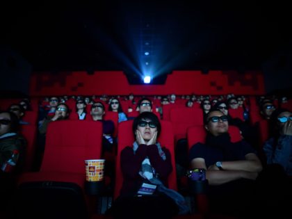 This picture taken on April 27, 2018 shows people watching a movie at a cinema in Wanda Gr
