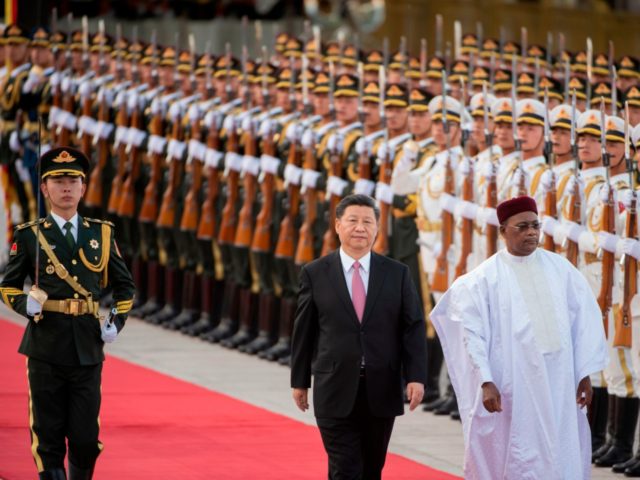 Niger President Mahamadou Issoufou (R) and Chinese President Xi Jinping (C) inspect honour guards during a welcome ceremony at the Great Hall of the People in Beijing on May 28, 2019. (Photo by NICOLAS ASFOURI / AFP) (Photo credit should read NICOLAS ASFOURI/AFP/Getty Images)
