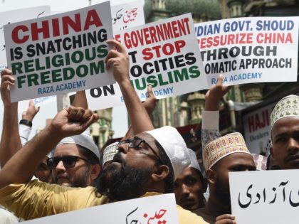 Indian Muslims hold placards during a protest against the Chinese government over the detention of Muslim minorities in Xinjiang, in Mumbai on September 14, 2018. - China has long imposed draconian restrictions on the lives of Muslim minorities in its Xinjiang region in the name of combating terrorism and separatism, …