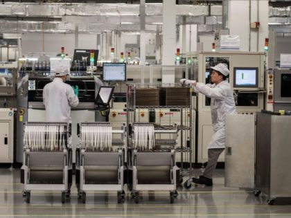 Workers are seen on the production line at Huawei's production campus on April 11, 2019 in
