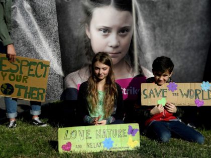 TOPSHOT - 9-year-old pupil Alice (C), dubbed the "Italian Greta", and a boy hold placards