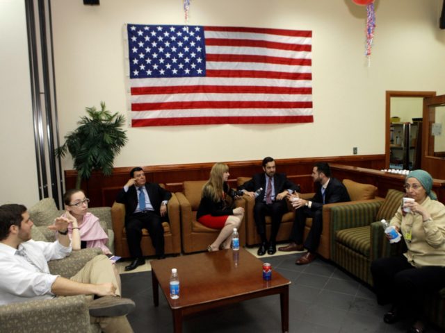 In this Nov. 7, 2012 file photo. U.S. embassy staff sit under a national flag at the U.S.