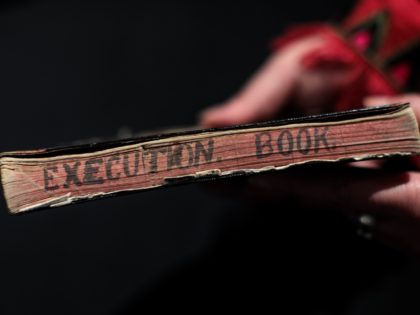 BILLINGSHURST, ENGLAND - MAY 30: An employee holds hangman Henry Pierrepoint's execution notebook from a collection of crime memorabilia linked to his son and executioner Albert Pierrepoint (estimate £25,000 - 40,000) during a press preview at Summers Place Auctions on May 30, 2018 in Billingshurst, England. Summers Place Auctions are …