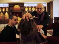 Father Elias Rahal, 68, performs exorcism ritual on a Lebanese lady at a church in the district of Mina in the northern port city of Tripoli on April 19, 2018. (Photo by IBRAHIM CHALHOUB / AFP) (Photo credit should read IBRAHIM CHALHOUB/AFP/Getty Images)