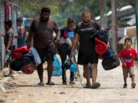 Honduras migrants leave the shelter they were staying at, after temporary permission to stay in Mexico, in Mapastepec, Chiapas state, Mexico, Sunday, April 28, 2019. This week, Central American migrants who traveled in caravans to the U.S. have begun receiving a Mexican government ID that allows them to stay for …