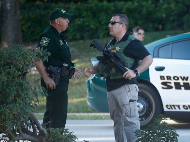 Law enforcement officers block off a street leading to Marjory Stoneman Douglas High Schoo
