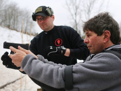 Students learn to fire their pistols at a class taught by King 33 Training at a shooting range on February 24, 2013 in Wallingford, Connecticut. King 33 Training, a company that trains and educates individuals on the safe and proper use of guns and other uses of protective force, offers …