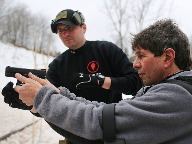Students learn to fire their pistols at a class taught by King 33 Training at a shooting r