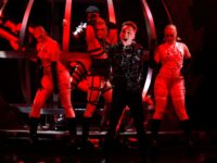 Hatari of Iceland perform the song "Hatrio mun sigra" during the 2019 Eurovision Song Contest grand final in Tel Aviv, Israel, Saturday, May 18, 2019. (AP Photo/Sebastian Scheiner)