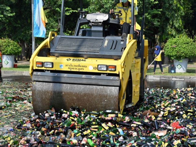 This picture shows a heavy machine being used to destroy bottles of liquors from the recen