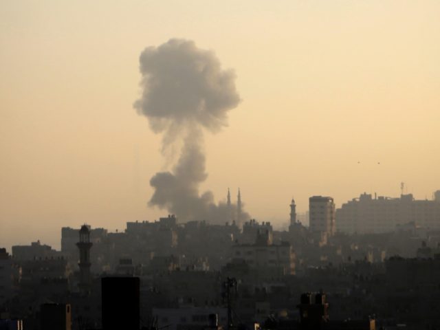 Smoke billows above buildings in Gaza City during an Israeli airstrike on the Palestinian