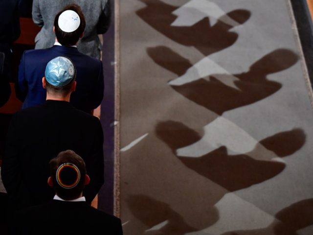 Men wearing Jewish kippa skullcaps attend a ceremony at the Synagogue Rykestrasse in Berli