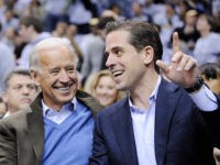President Barack Obama, left, talks with Vice President Joe Biden, center, and his son Hunter Biden, right, at the Duke Georgetown NCAA college basketball game, Saturday, Jan. 30, 2010, in Washington. (AP Photo/Nick Wass)