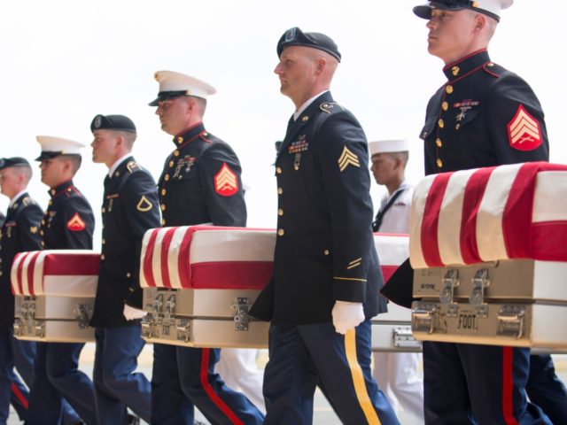 HONOLULU, HI - AUGUST 01: U.S. military carry the presumed remains of Korean War soldiers at Hangar 19 Joint base Pearl Harbor Hickam on August 1, 2018 in Honolulu, Hawaii. The remains of 55 service members were flown to Hawaii after being handed over by North Korea. (Photo by Kat …