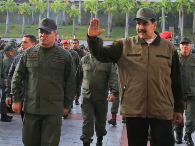 In this photo released by Miraflores Press Office, Venezuela's President Nicolas Maduro, r