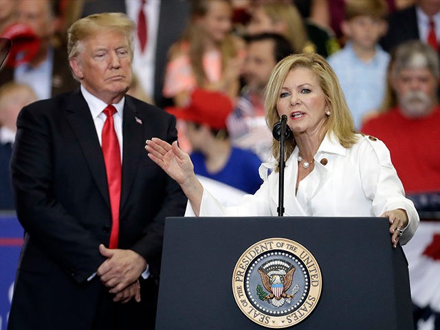 FILE - In this May 29, 2018 file photo, President Donald Trump listens as Rep. Marsha Blackburn, R-Tenn., speaks at a rally at the Nashville Municipal Auditorium in Nashville, Tenn. Blackburn is supposed to do well among Tennessee’s hog farmers and whiskey makers. Yet the Republican Senate candidate is struggling …