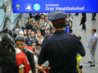 Migrants queue to board buses upon their arrival in Graz on September 20, 2015. Some 150 migrants entered Austria from across the Slovenian border today, opening up a new route for the thousands seeking to cross the Balkans into northern Europe. AFP PHOTO / JURE MAKOVEC (Photo credit should read …