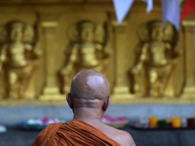 A Sri Lankan's Buddhist monk prays for the bomb blast victims at Kelaiya temple in Colombo