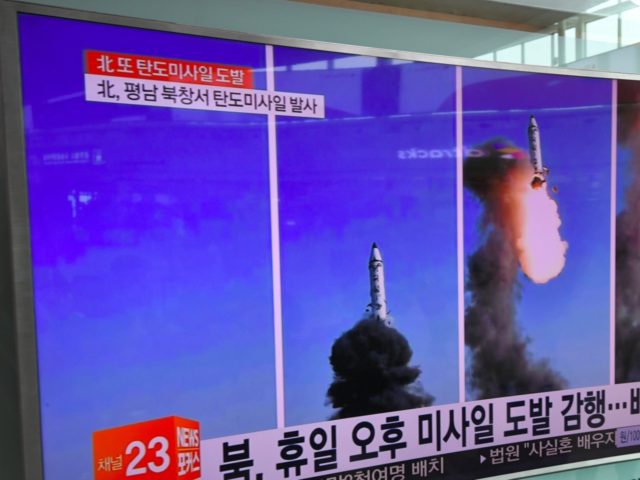 People walks past a television showing a news report on North Korea's latest missile test of a Pukguksong-2, at a railway station in Seoul on May 22, 2017. North Korea on May 22 declared its medium-range Pukguksong-2 missile ready for deployment after a weekend test, the latest step in its …