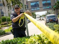HOLLYWOOD, FL - SEPTEMBER 13: A Hollywood Police Department officer wraps crime scene tape around a perimeter surrounding a rehabilitation center where six patients were found dead September 13, 2017 in Hollywood, Florida. The deaths may be due to to the home's loss of air conditioning after Hurricane Irma struck …