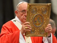 Pope Francis holds aloft the book of the gospels as he leads a mass for the imposition of the Pallium upon the new metropolitan archbishops and the solemnity of Saints Peter and Paul on June 29, 2014 at St Peter's basilica in Vatican. AFP PHOTO / VINCENZO PINTO (Photo credit …