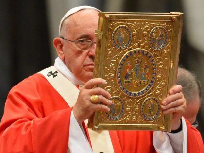 Pope Francis holds aloft the book of the gospels as he leads a mass for the imposition of the Pallium upon the new metropolitan archbishops and the solemnity of Saints Peter and Paul on June 29, 2014 at St Peter's basilica in Vatican. AFP PHOTO / VINCENZO PINTO (Photo credit …