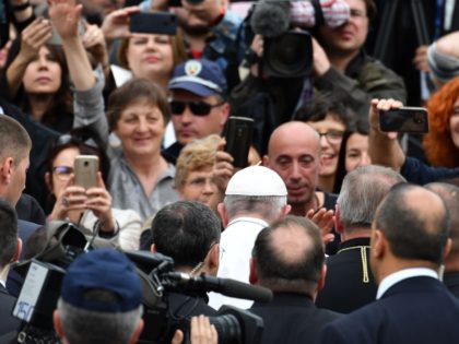 Pope Francis is surrounded by journalists and aides as he arrives to celebrate a Holy Mass on Knyaz Alexander I square in the Bulgarian capital Sofia, on May 5, 2019. - Pope Francis arrived in Bulgaria, where he will meet members of the tiny Catholic community, but the main Orthodox …