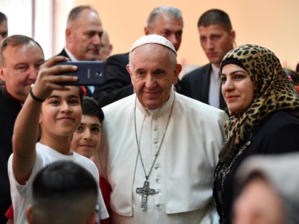 Pope Francis poses for a selfie with young refugees during a visit to the Vrazhdebna refugee camp, on the outskirts of the Bulgarian capital Sofia, on May 6, 2019. - Pope Francis urged Bulgarians to open their hearts and doors to refugees during a visit to the European Union's poorest …