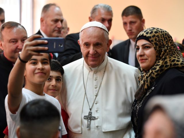 Pope Francis poses for a selfie with young refugees during a visit to the Vrazhdebna refug