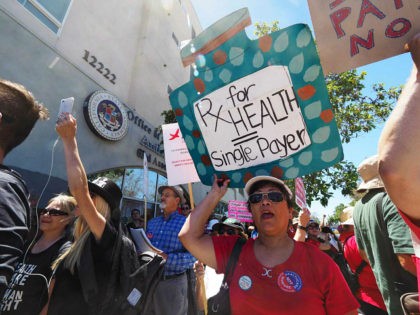 People rally in favor of single-payer healthcare for all Californians as the US Senate prepares to vote on the Senate GOP health care bill, outside the office of California Assembly Speaker Anthony Rendon, June 27, 2017 in South Gate, California. Rendon announced last week that Senate Bill SB 562 - …